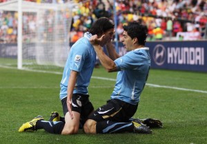 PORT ELIZABETH, SOUTH AFRICA - JUNE 26:  Luis Suarez of Uruguay (R) celebrates scoring with teammate Edinson Cavani during the 2010 FIFA World Cup South Africa Round of Sixteen match between Uruguay and South Korea at Nelson Mandela Bay Stadium on June 26, 2010 in Nelson Mandela Bay/Port Elizabeth, South Africa.  (Photo by Alex Livesey - FIFA/FIFA via Getty Images)